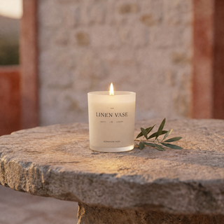 Geranium Sage Signature Candle lit on a Mediterranean terrace at dusk
