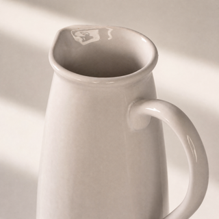 Close up of the Watermill Jug showing the texture of its soft white glaze in natural light