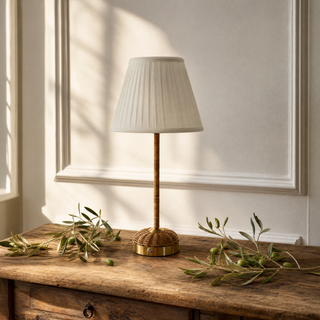 Lucia Rattan Cordless Lamp Base with a cream pleated lampshade