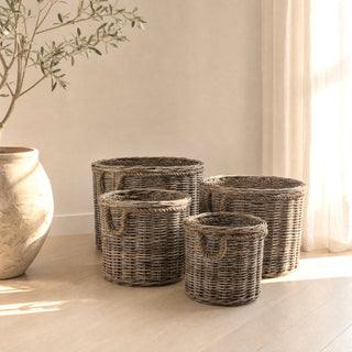 The Grey Rattan Basket with Jute Handles set of four in a sunlit coastal interior