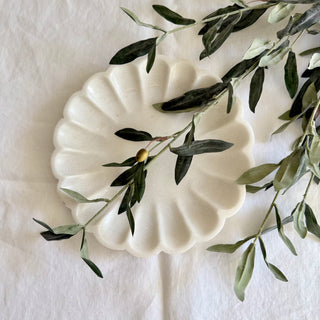 Faux olive stems styled on the Signature Pure Linen Tablecloth in Arctic White