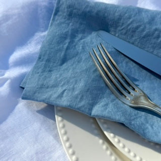 Signature Pure Linen Napkins in Amalfi Blue folded on the table