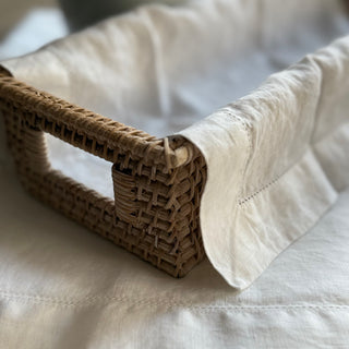 Willa Rattan Narrow Display Tray styled in a quiet luxury setting
