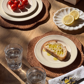 Willa Rattan Scalloped Edged Chargers on a table setting